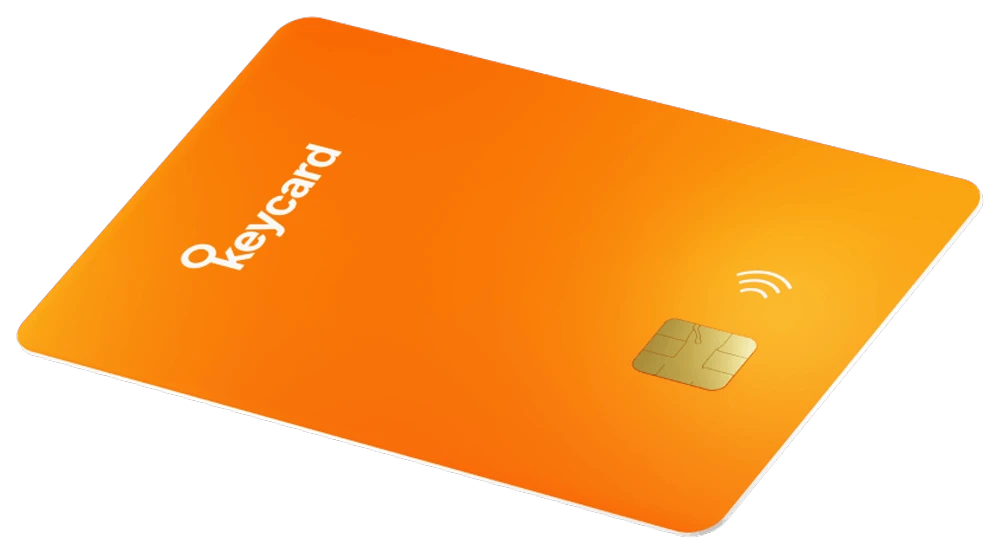 An orange Keycard, with its secure-element chip and NFC mark